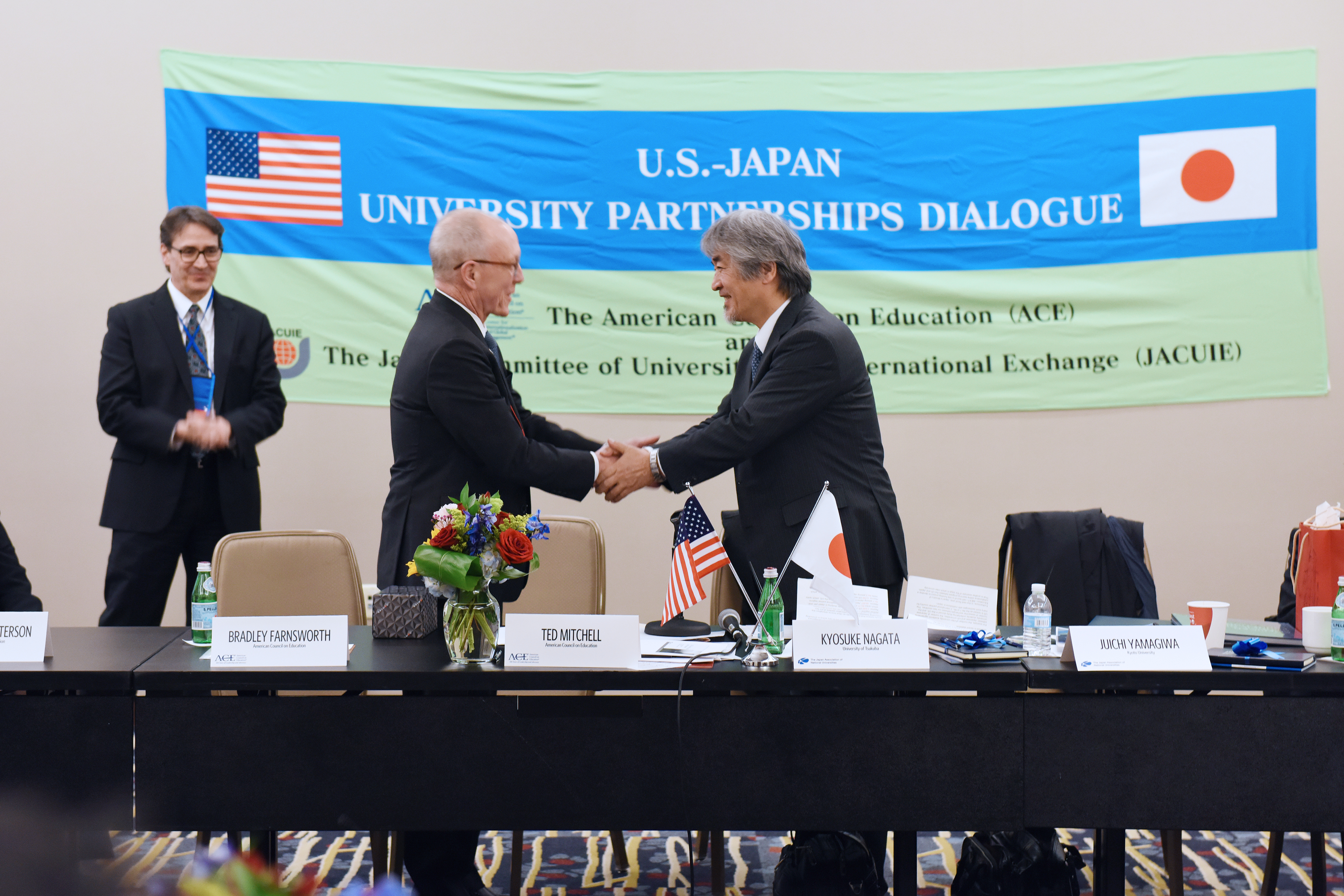 Picture of Ted Mitchell shaking hands with Juichi Yamagiwa.