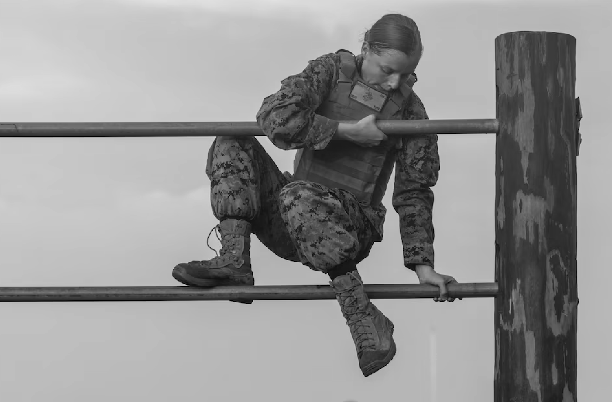 Woman in military uniform climbing