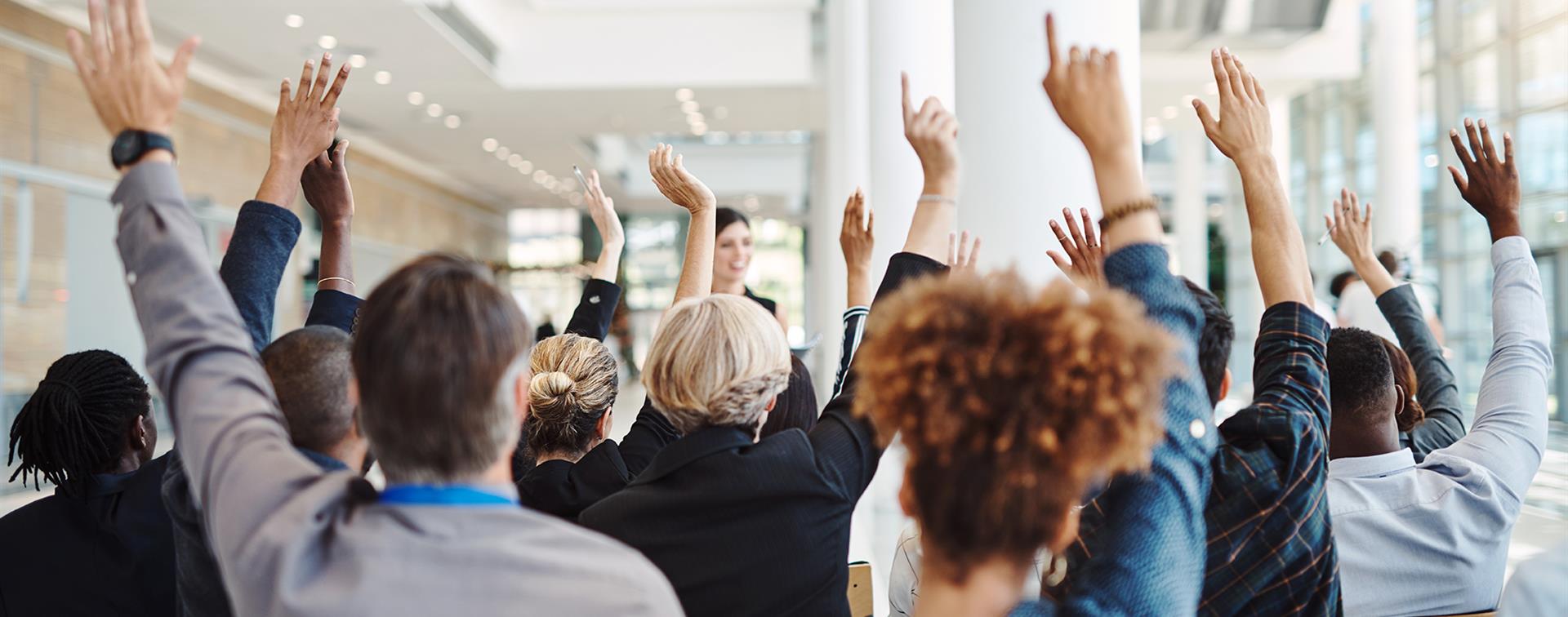 People raising their hands for questions