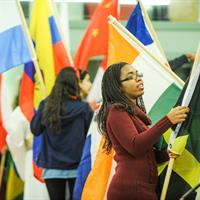 Picture of students carrying various national flags