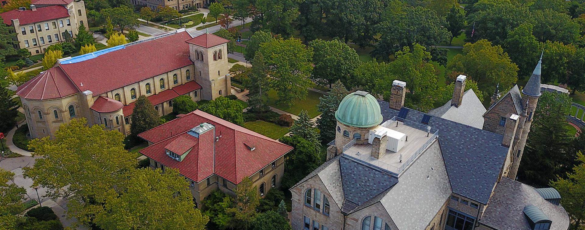 Old stone buildings on a college campus, viewed from above