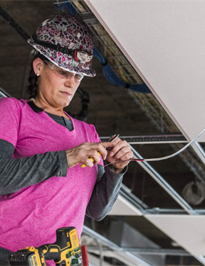 Picture of a woman working on electrical work. 