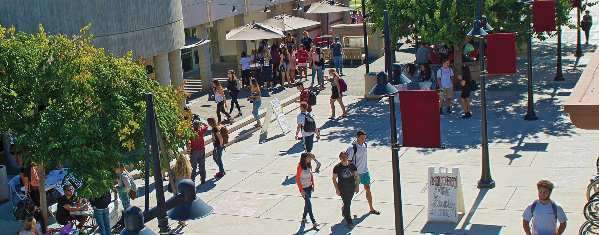 Picture of a campus center with students walking.
