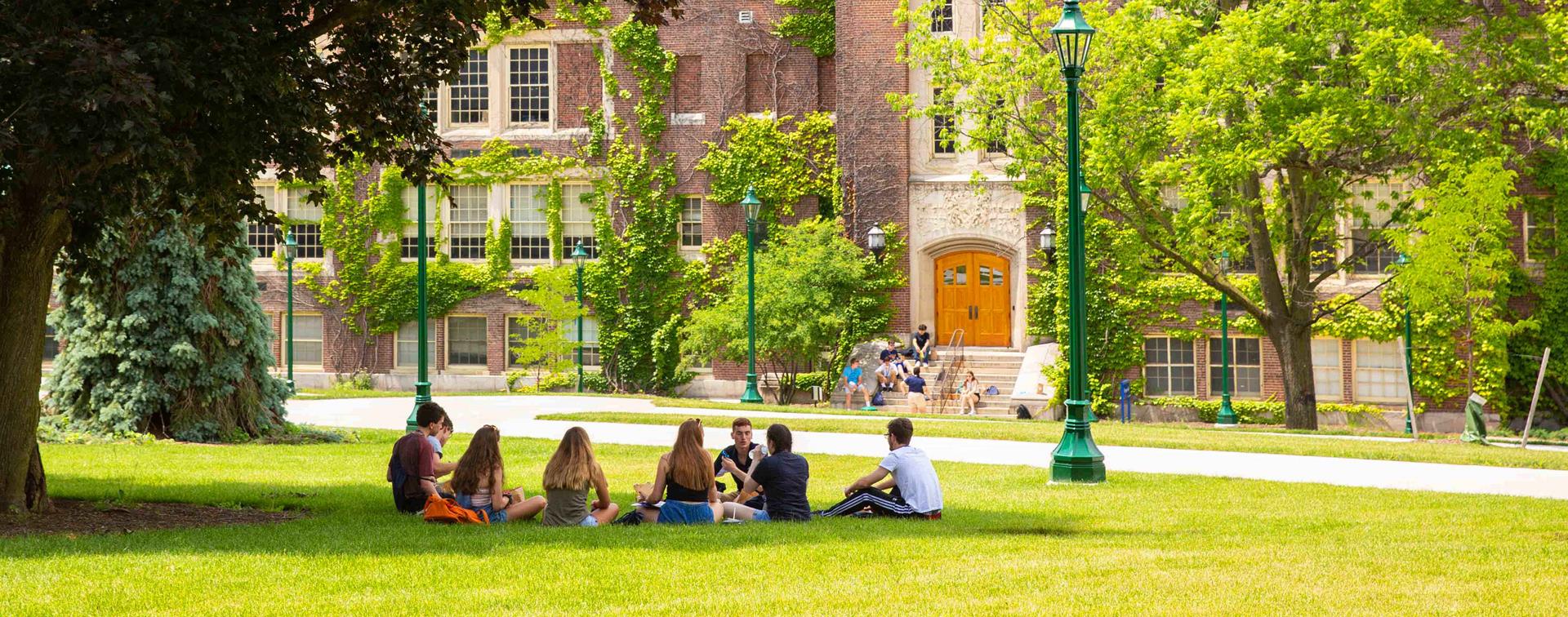 Photo of students meeting in front of a building at SUNY Geneseo