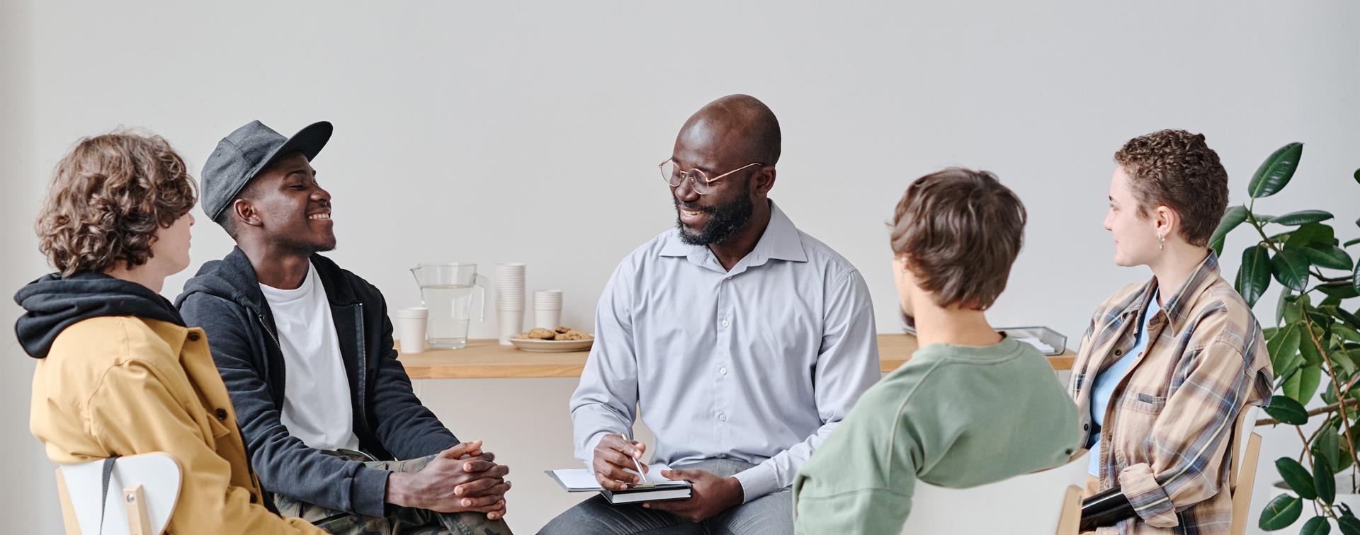 Image of people sitting together and conversing.