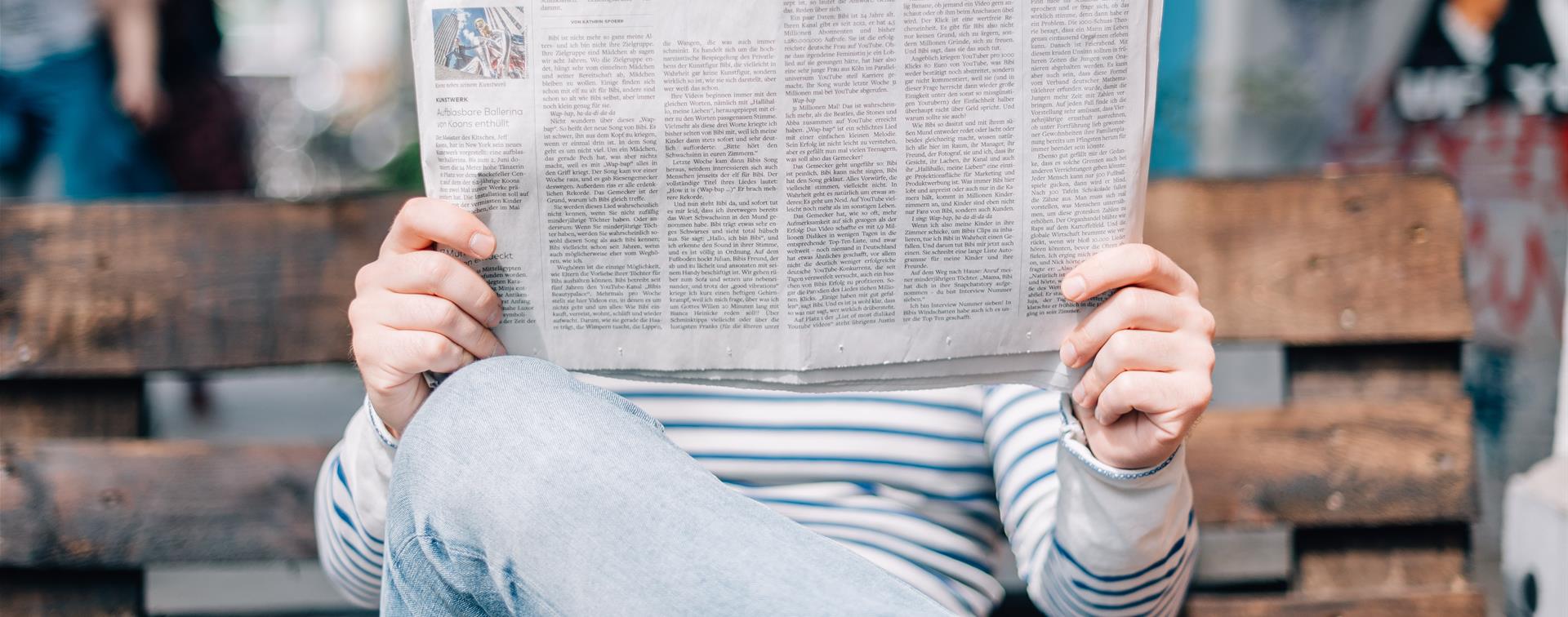 A picture of a man reading a newspaper