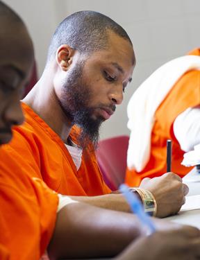 Photo of student in Georgetown Prison Scholars Program working at desk