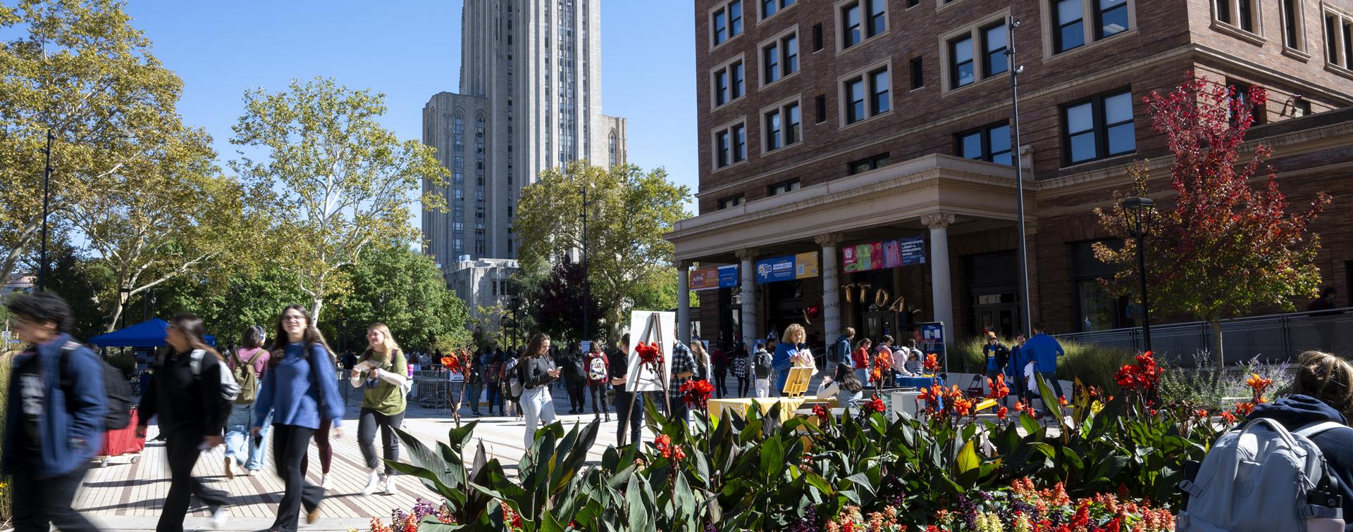 Photo of students walking around the University of Pittsburgh campus on a sunny day