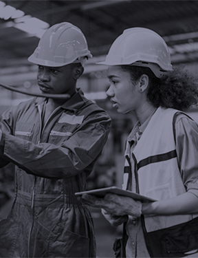 Man and woman in hard hats and safety vests